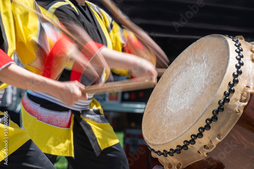 A Taiko drummer performs on stage 