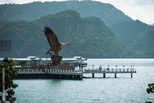 Big Eagle statue perched over a scenic waterfront plaza in Langkawi, Malaysia.
