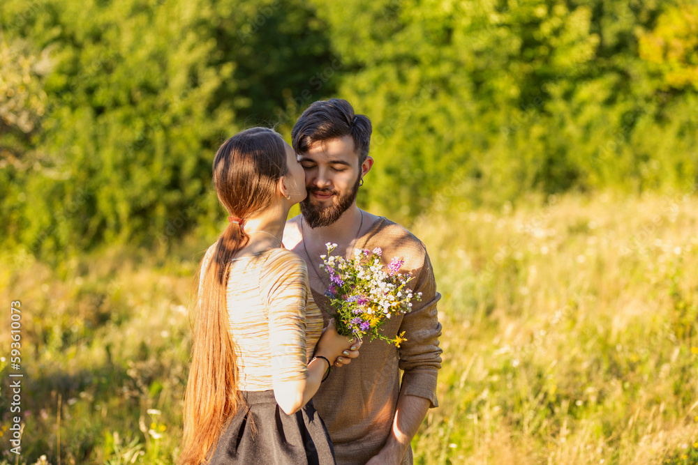 man giving wild flowers to his girlfriend man giving wild flowers to his girlfriend