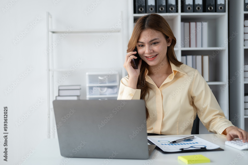 Young beautiful businesswoma having a phone call with her coworker at office room. Young beautiful businesswoma having a phone call with her coworker at office room.