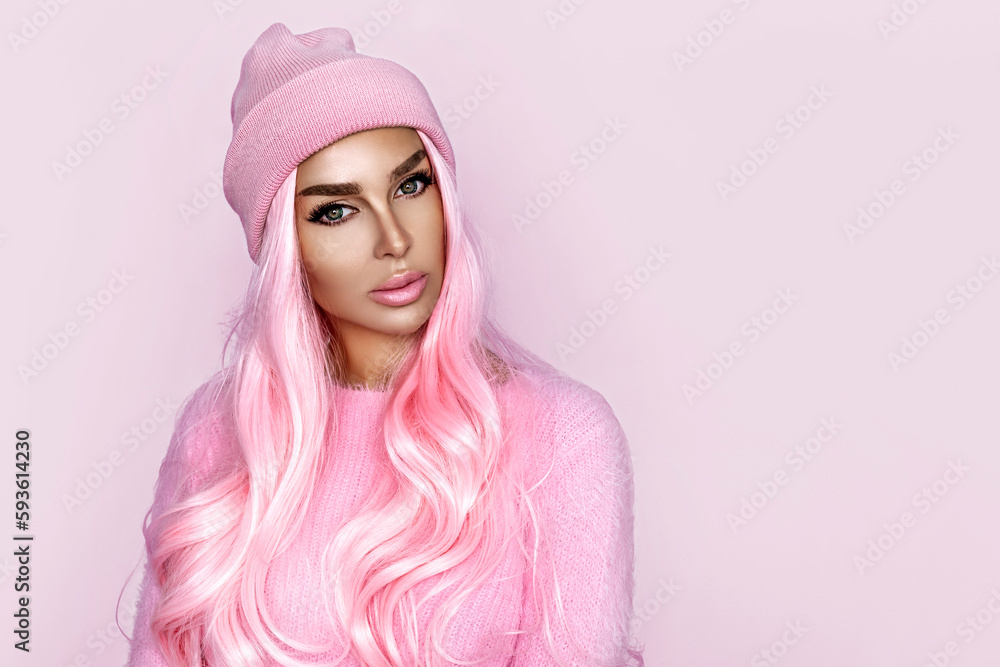 Sexy young girl is wearing pink summer hat and pink sweater over white background. Spring summer fashion. Skate style. Sexy young girl is wearing pink summer hat and pink sweater over white background. Spring summer fashion. Skate style.