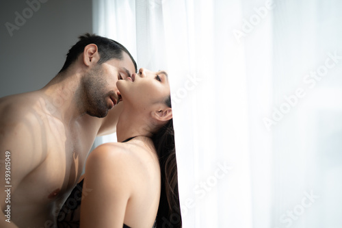 Gorgeous sexy couple enjoying sex in the house s bedroom  Concept of as emotional relationships passion and love