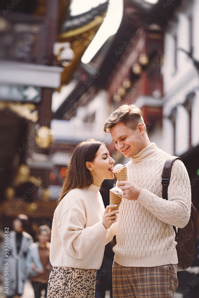 newlywed couple eating ice cream from a cone on a street in Shanghai near Yuyuan China. newlywed couple eating ice cream from a cone on a street in Shanghai near Yuyuan China.