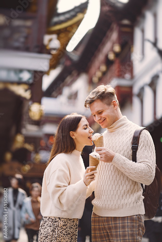 Canvas Print newlywed couple eating ice cream from a cone on a street in Shanghai near Yuyuan China