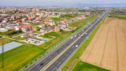 Aerial view of a section of the Italian motorway. On the left the town of Afragola, near Naples and Caserta, Italy.
