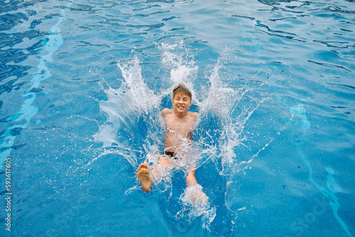Child jump, swim in the pool, sunbathes, swimming in hot summer day. Relax, Travel, Holidays 