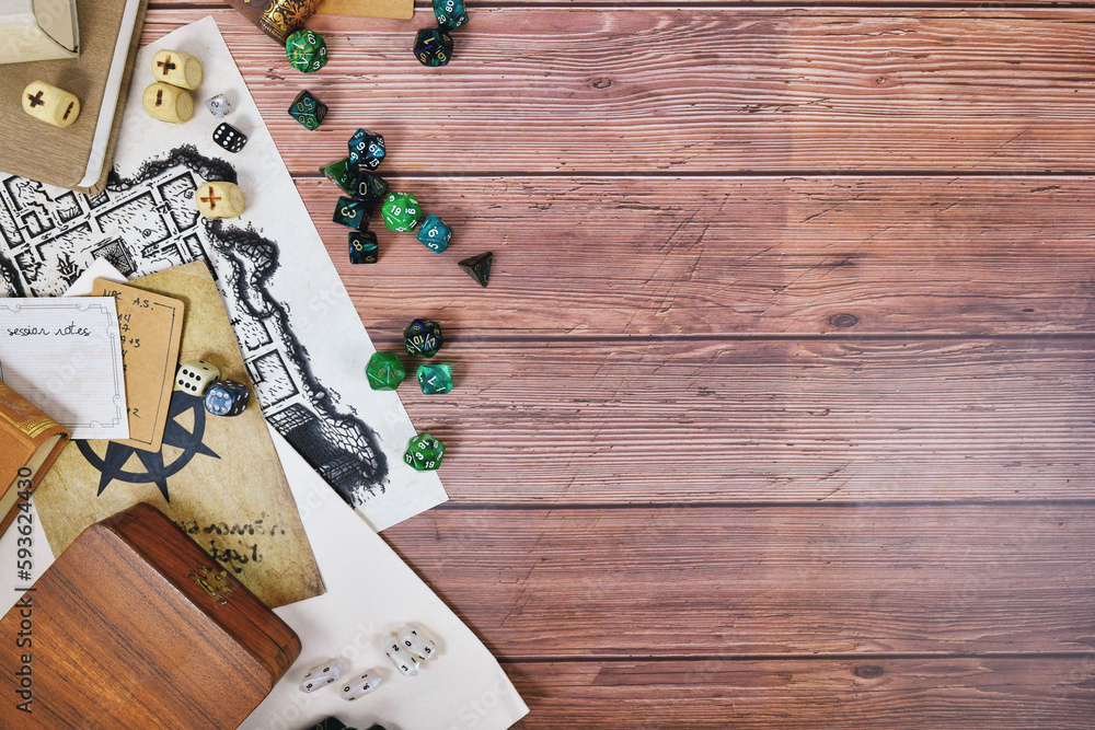 Tabletop role playing flat lay background with colorful RPG dices, rule books and notes on wooden background with copy space - obrazy, fototapety, plakaty 