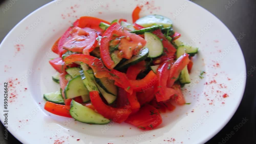 Smooth camera movement, selective focus, close-up of a plate with vegetable salads on a black wooden table. Smooth camera movement, selective focus, close-up of a plate with vegetable salads on a black wooden table.
