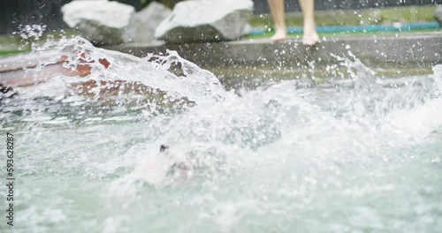 Wallpaper Mural Playful black and white border collie fun play at swimming pool. Happy cute dog jump and dive to catch up toy into water. Summer activities, training sport exercise Family pet lifestyle. slow motion. Torontodigital.ca