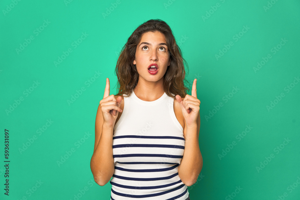 Young caucasian woman isolated pointing upside with opened mouth. Young caucasian woman isolated pointing upside with opened mouth.
