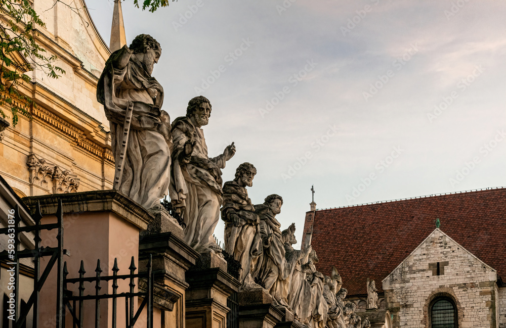 Fototapeta premium Beautiful gothic facade and statues of the catholic Church of the Holy Apostles Peter and Paul in the historical district of Krakow