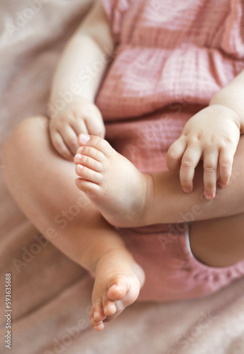 Close-up barefoot newborn baby feet and hands. Selective focus.