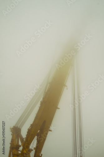 Dźwig do montażu instalacji wiatrowych na morzu w mglisty dzień. photo