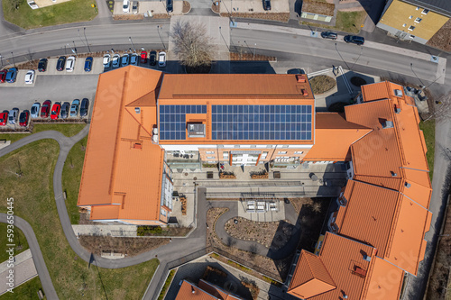 Aerial view on a big solar battery panel on a roof of a building. Energy-saving technology. European modern technology.