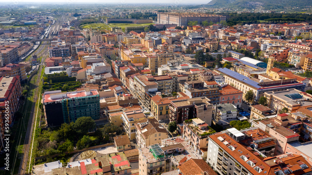 Aerial view of the historic center of Caserta, in Campania, Italy. In background the Royal Palace of Caserta also known as Reggia di Caserta, symbol of the city.