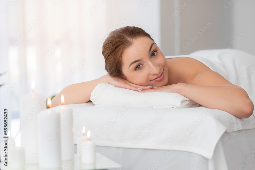 Beautiful indian woman lying on table in spa salon, waiting for massage Beautiful indian woman lying on table in spa salon, waiting for massage