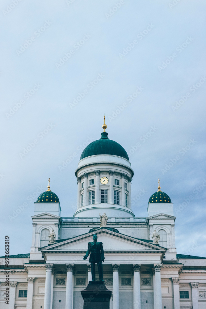 Minimalist look of lutheran finish cathedral over cloudy sky with green domes