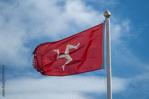 Isle of Man flag flying in the wind on a sunny day photo