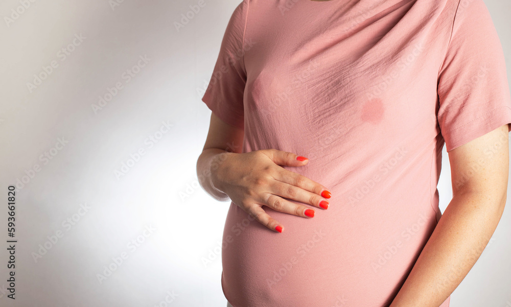 A soaked blouse from milk on the female breast of a nursing mother.  Leak-proof bra pads, close-up. Copy space for text Stock Photo