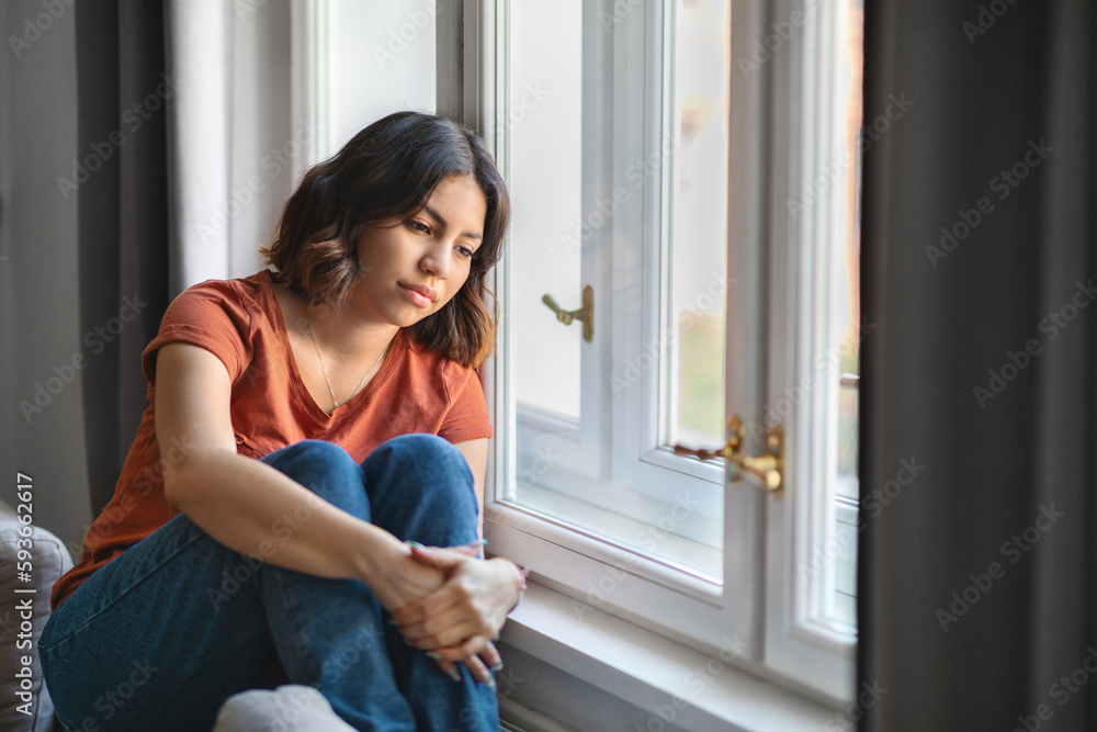 Seasonal Depression. Upset Pensive Young Arab Woman Sitting Near Window At Home