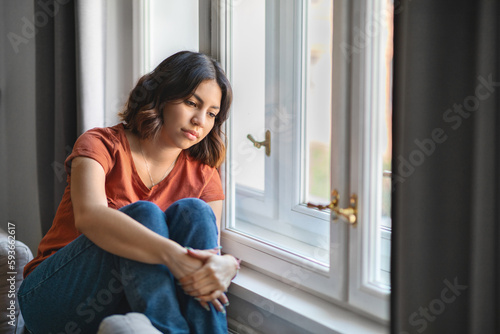 Fototapeta Naklejka Na Ścianę i Meble -  Seasonal Depression. Upset Pensive Young Arab Woman Sitting Near Window At Home