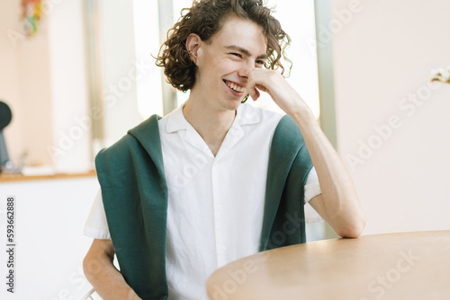 Teenager is Laughing at Table photo