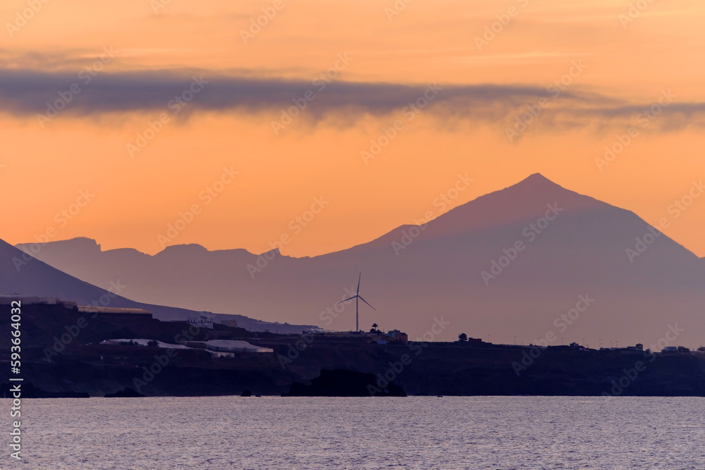 Beautiful view of Teide volcano and the island Tenerife from Las Canteras beach in Las Palmas de Gran Canaria, Spain at sunset.