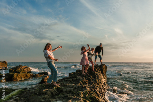 Fun and happy family at the beach in california photo