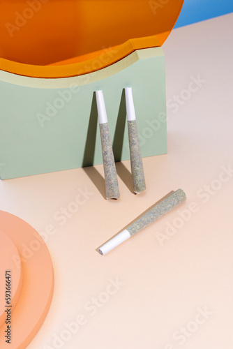 Cannabis prerolls with colorful objects photo