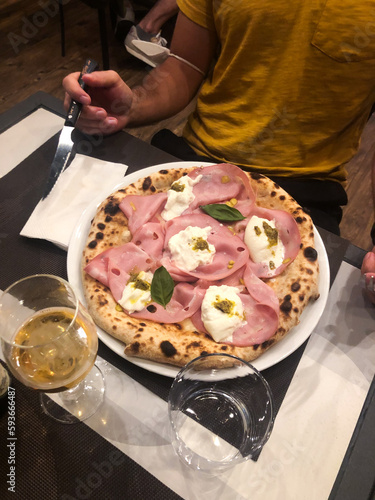 UGC mortadella pizza on restaurant table  photo