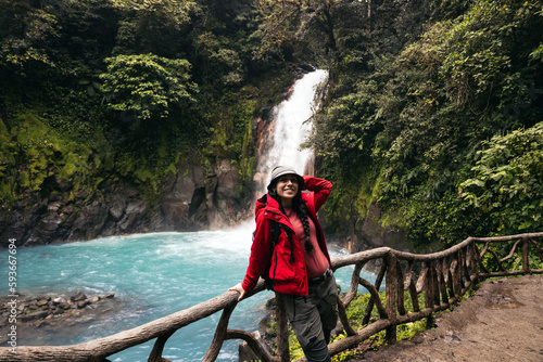 Woman visiting the Rio Celeste waterfall in Costa Rica photo