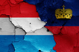 flags of Luxembourg and Liechtenstein painted on cracked wall
