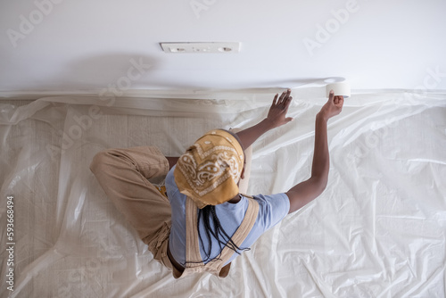 Black painter preparing for wall repainting