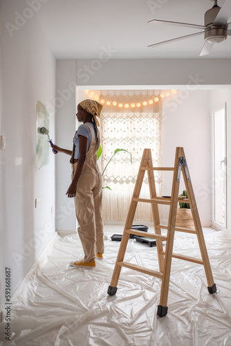 Black woman renovating new apartment in daytime