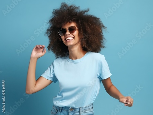 Glückliche Frau mit Afrolocken tanzt in lässigem T-Shirt und Sonnenbrille auf blauem Hintergrund, generative AI.