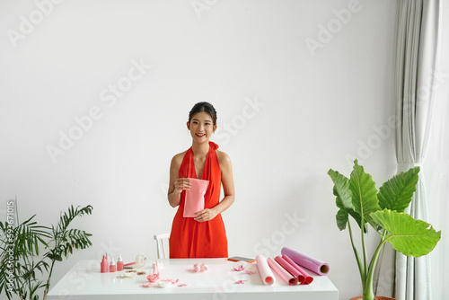 Beautiful woman packing products for customers in shockproof bag