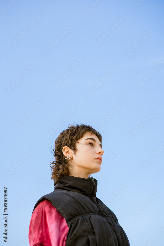 portrait of young woman posing on a sky background portrait of young woman posing on a sky background