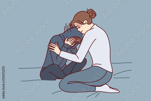 Mother consoles crying daughter who is depressed due to peer problems or poor school performance. Caring woman hugging and consoles crying girl after argument or house arrest related to bad behavior