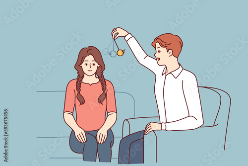 Man psychotherapist hypnotizes woman patient using pendulum to solve psychological problems in subconscious. Guy hypnotizes girl to take advantage unconscious state or remove information from memory 