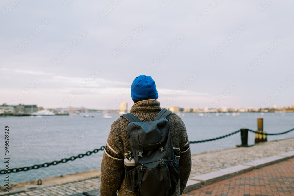 Middle Aged Man wearing backpack and blue hat in Boston Seaport Middle Aged Man wearing backpack and blue hat in Boston Seaport