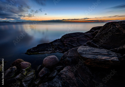 Beautiful view of rocky coastline and the Baltic Sea in Hanko, Finland, at dusk in the summer.