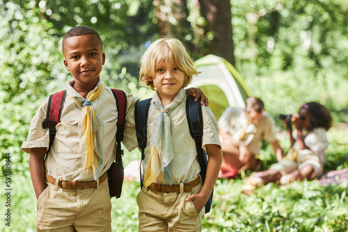Canvas Print Waist up portrait of two boy scouts looking at camera while camping with school