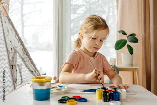 Female kid painting with gouache  photo