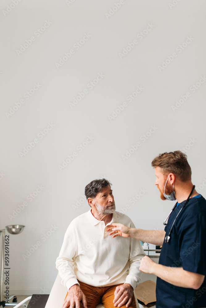 © Studio Firma/Stocksy - Doctor Examining Senior Man