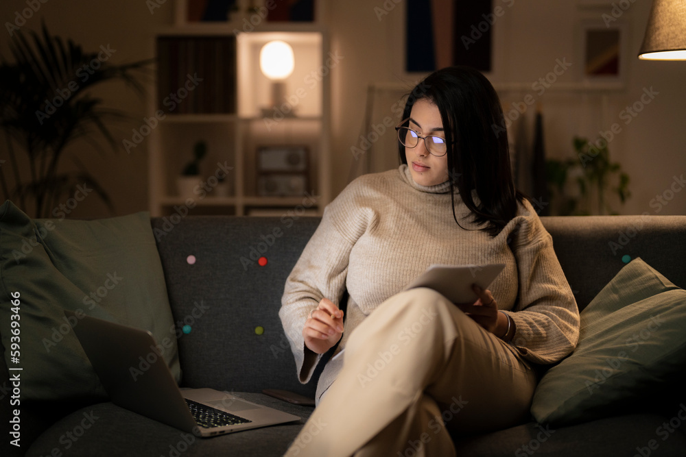 Woman working on laptop and with papers Woman working on laptop and with papers
