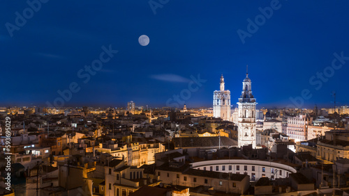 Aerial of night Valencia cityscape at dawn, white moonn in the clear sky photo