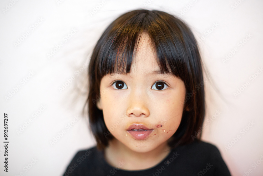 Close up portrait of little asian girl just finished eating Close up portrait of little asian girl just finished eating