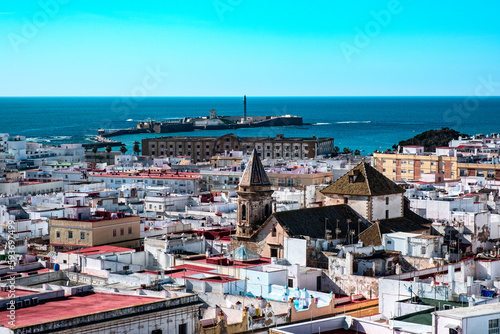 An aerial top view of the roofs of Cadiz, El Castillo de San Sebastian and Atlantic ocean, from the tover Torre Tavira . Andalusia, Spain