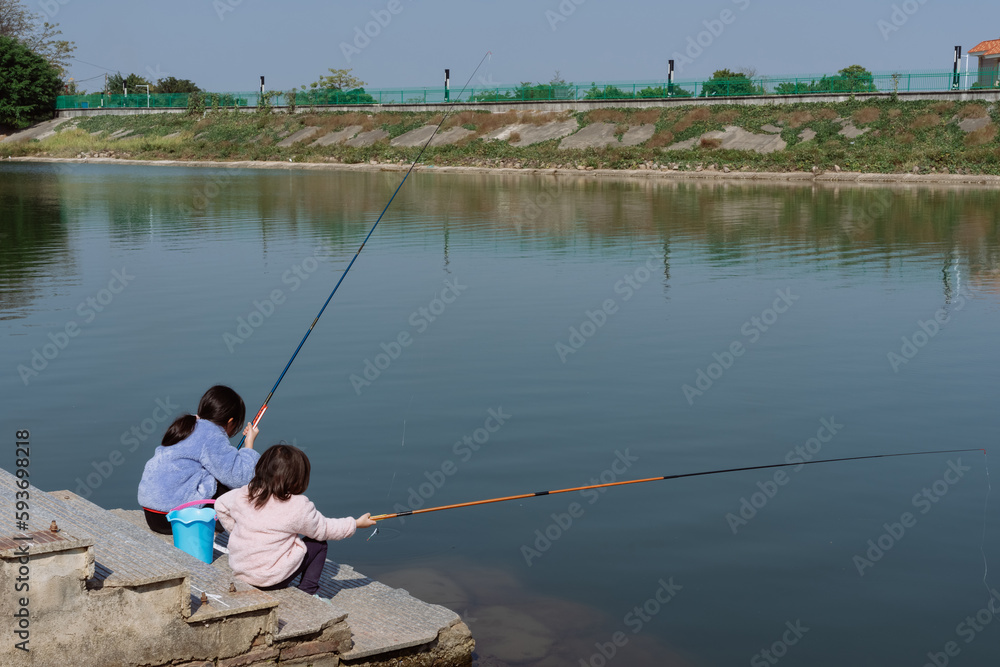 child learning to fish by the river child learning to fish by the river