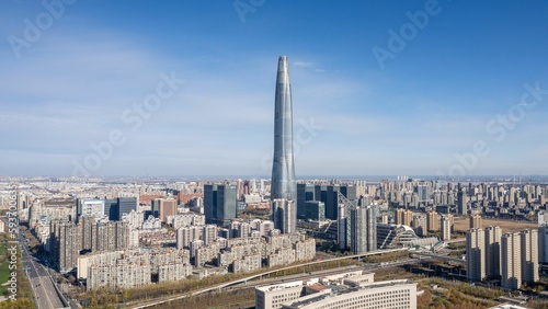 Aerial shot of a high tower building in Tinajin and other modern buildings